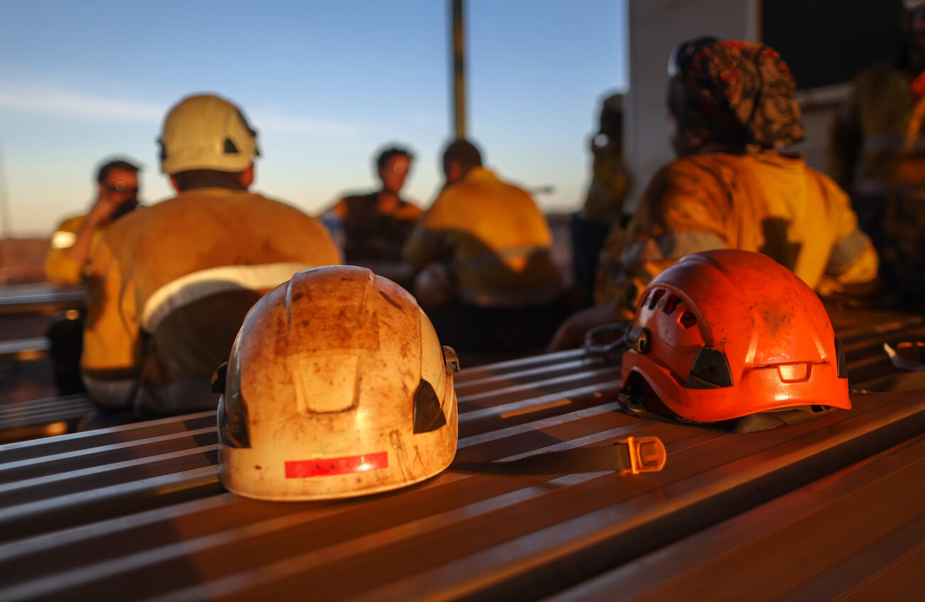 helmets on a lunch bench at a mine site