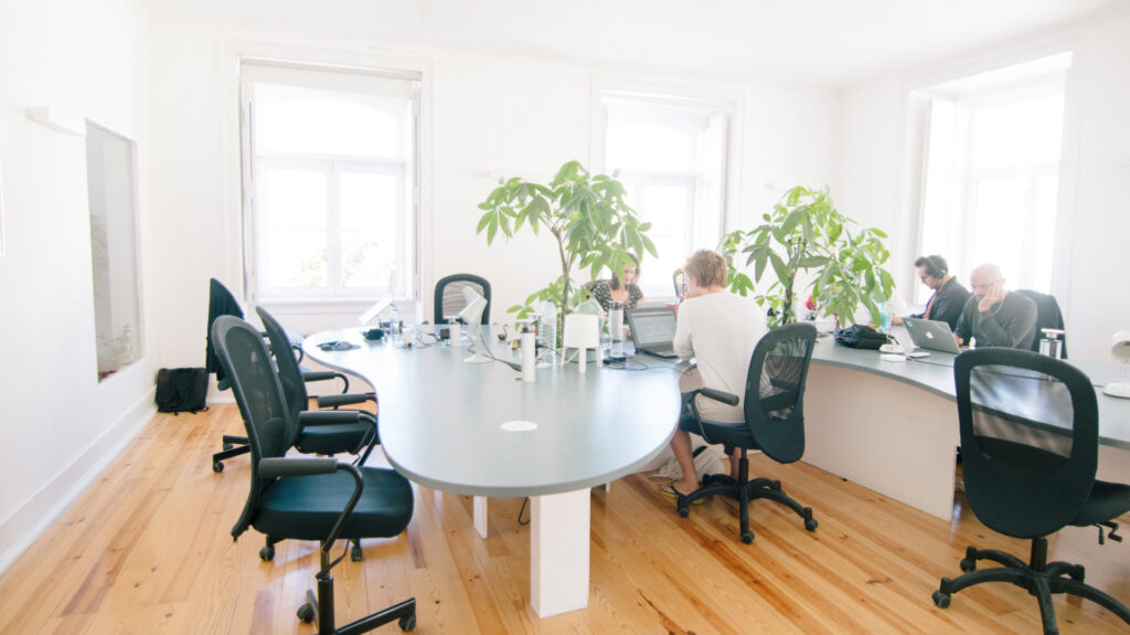 some people sitting in a brightly lit office